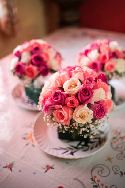 The bridesmaids bouquets of red and pink roses.
