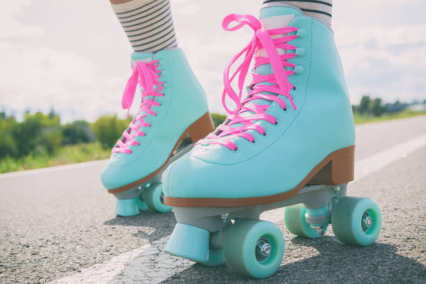 Woman wearing roller skates with pink laces Woman rollerskater wearing roller skates with pink laces roller skating stock pictures, royalty-free photos & images