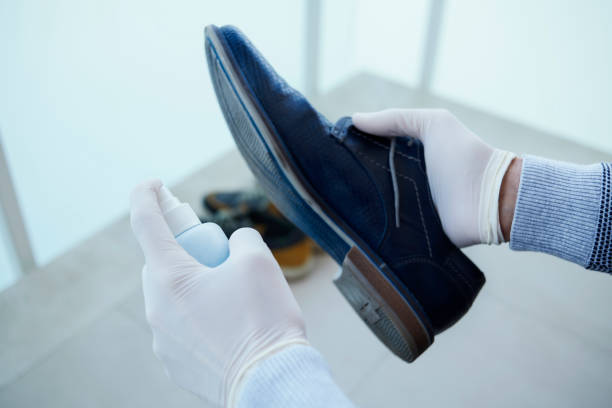 istock man disinfecting his shoes 1220743950