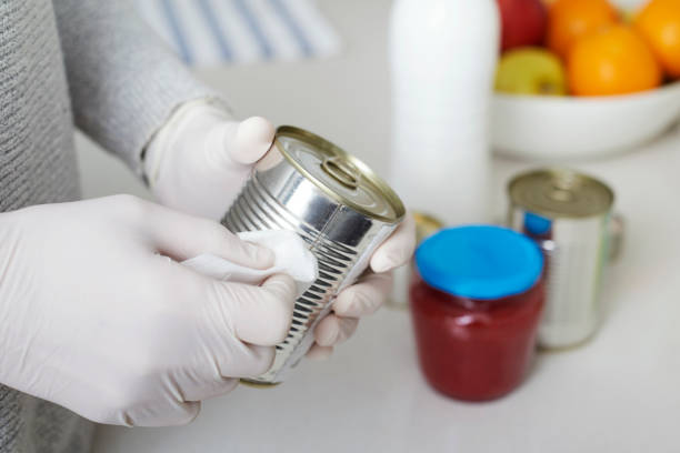 istock man disinfecting the purchases 1220743985