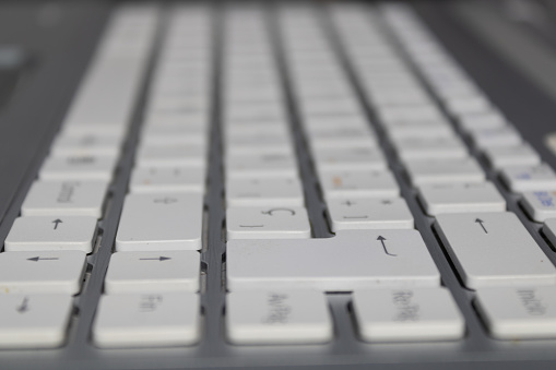 grey laptop keyboard with white keys