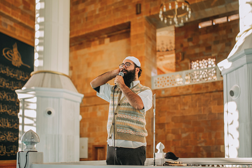Muslim man is praying in mosque