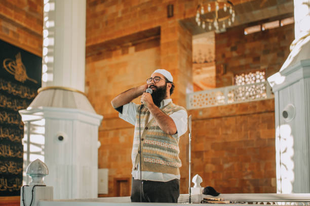 muslim man is reading adhan in mosque - adhan imagens e fotografias de stock