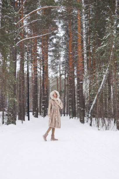 istock Beautiful woman in winter park 1220746324