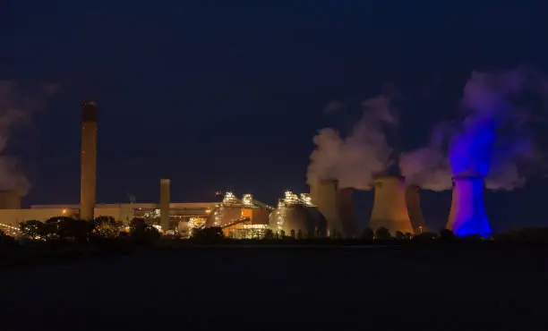 Stunning effect of a blue light on one of the cooling towers of a power station at Drax in North Yorkshire. In support of Thursday night's Clap for Carers during the Coronavirus pandemic.  Night image. Horizontal.  Space for copy.
