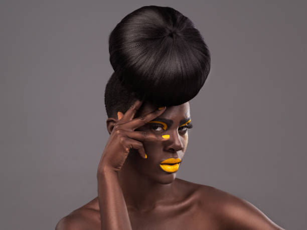 Studio portrait of a beautiful young woman posing against a grey background