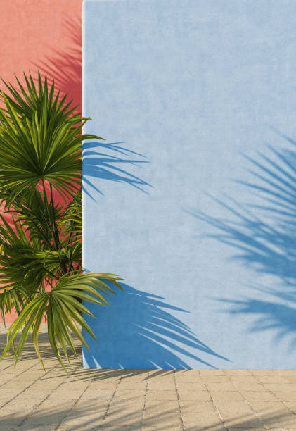 istock Painted blue and red wall with green tropical leaves, sunlight with shadows. Summer, spring background. 3d rendering. 1220749379
