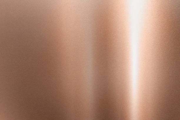 istock Light shining down on  bronze hard metal wall with copy space, abstract texture background 1220749660