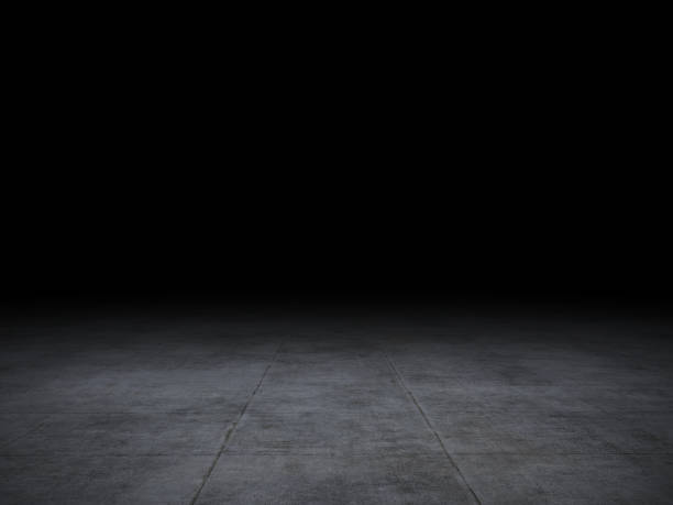 istock Black background with spotlight to concrete ground. Dark interior background, with tile or cement and concrete floor. 1220751465