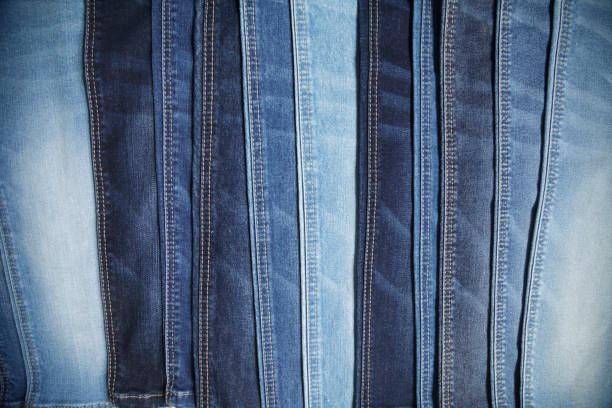 istock Many blue jeans arranged in a row background 1220752912