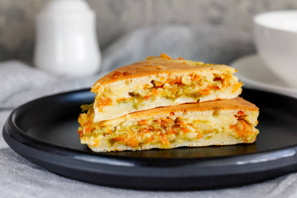 pieces of pie with fresh young cabbage and carrots - baked breakfast cabbage cake imagens e fotografias de stock