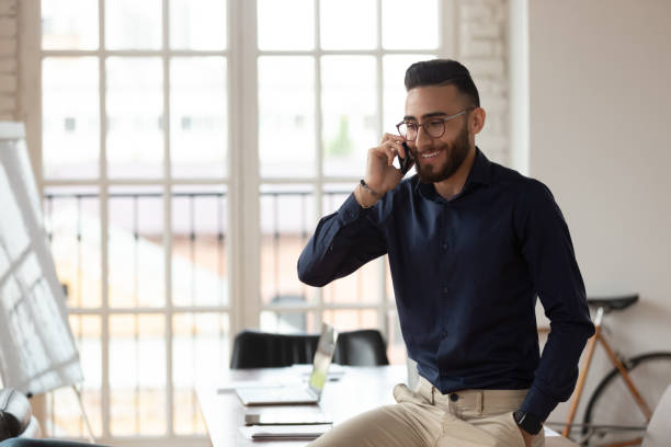 istock Middle eastern ethnicity employee inside of boardroom talking on phone 1220758976