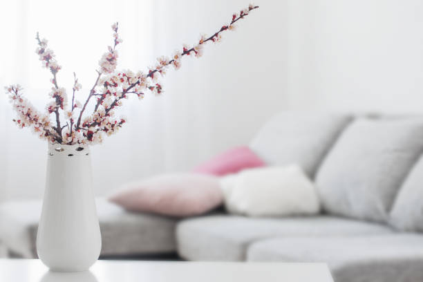 spring pink flowers in vase in white interior