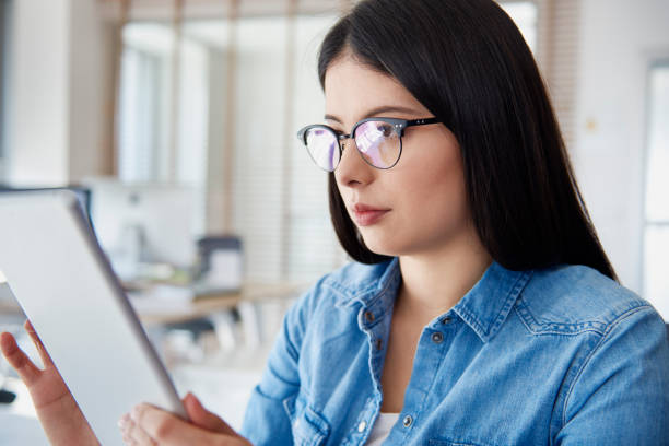 istock Asian woman using digital tablet in the office 1220762044