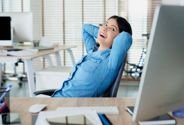 istock Satisfied Asian woman having a break in the office 1220762083