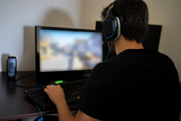 istock Teenager playing games on PC 1220762265