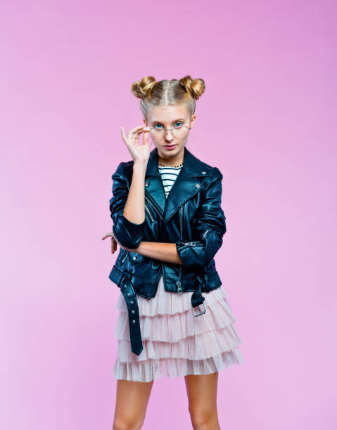 istock Confident stylish teenege girl peeking over eyeglasses 1220762829