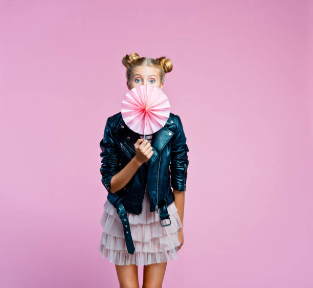 cute teenege girl covering her mouth with origami fans wheel - circular skirt fotos imagens e fotografias de stock