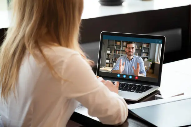 Photo of Employer listen applicant during job interview using webcam and pc