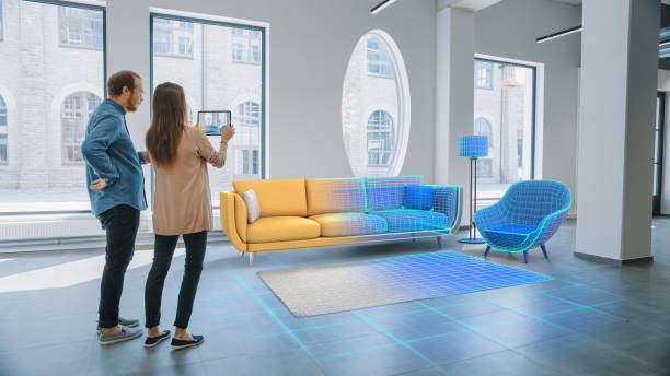 utsmyckning lägenhet: lovely young couple använd digital tablet med augmented reality interior design software att välja 3d-möbler för sitt hem. människor väljer soffa, bord och belysning för vardagsrum - augmented reality bildbanksfoton och bilder