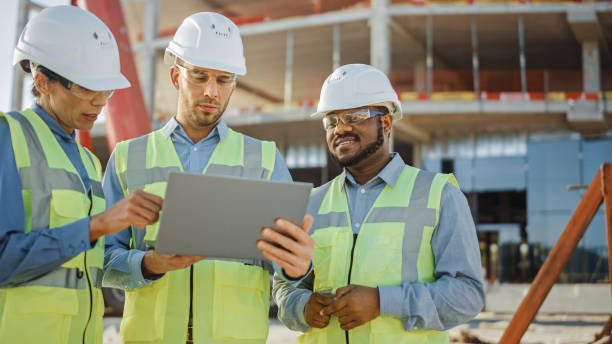 istock Diverse Team of Specialists Use Laptop on Construction Site. Real Estate Building Project with Engineer Investor and Businesswoman Checking Area, working on Civil Engineering, Discussing Strategy Plan 1220765720