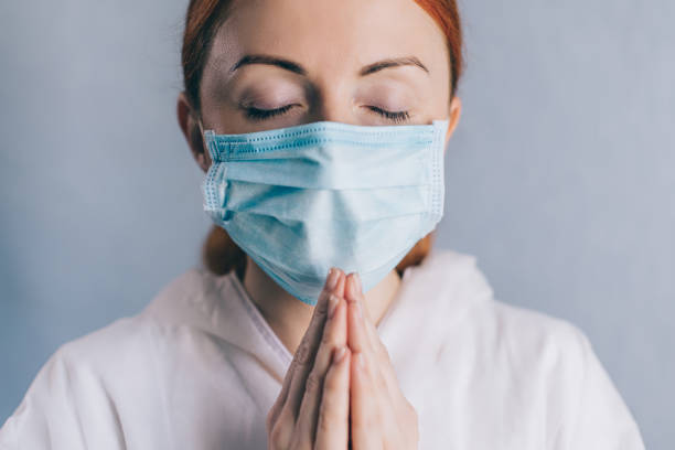 istock A female doctor is praying. Close up. 1220770746