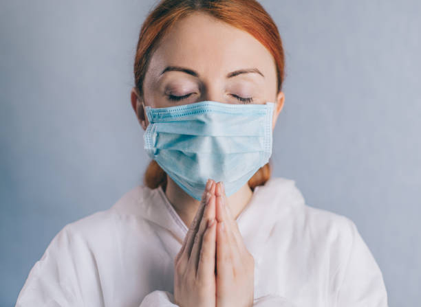 istock A female doctor is praying. Close up. 1220770748