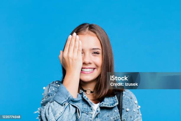 Cheerful Pretty Teenege Girl On Blue Background Stock Photo - Download Image Now - Teenage Girls, Ecstatic, Excitement