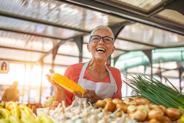 istock Female farmer holding vegetables 1220776564