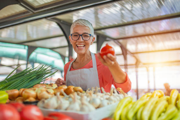 istock Female farmer holding vegetables 1220776623