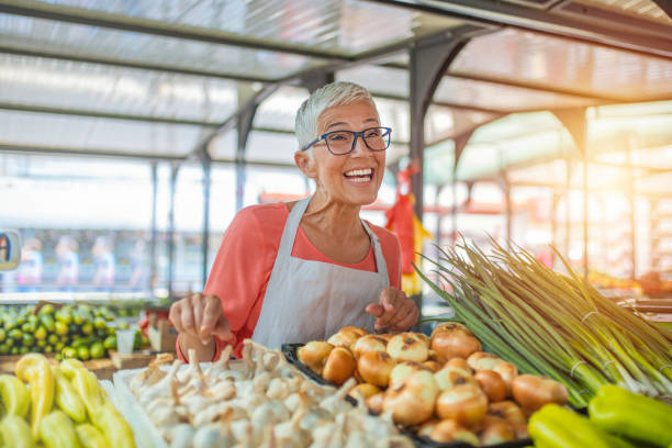 istock Friendly woman tending an organic vegetable 1220776624