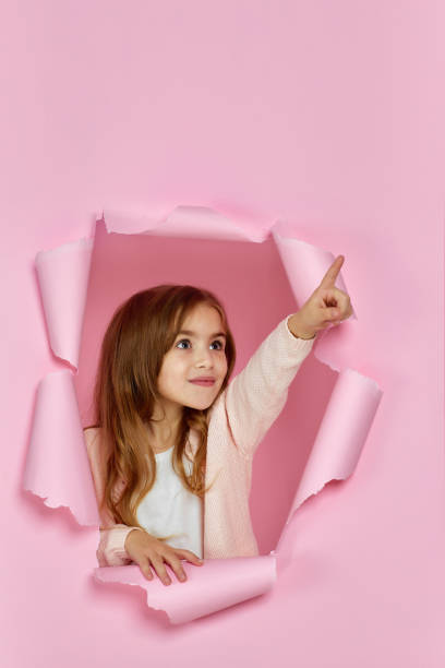 istock little child girl pointing on copy space 1220777877