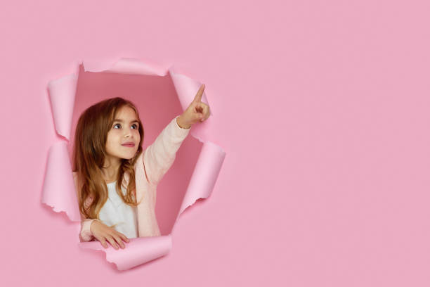 istock little child girl pointing on copy space 1220777916