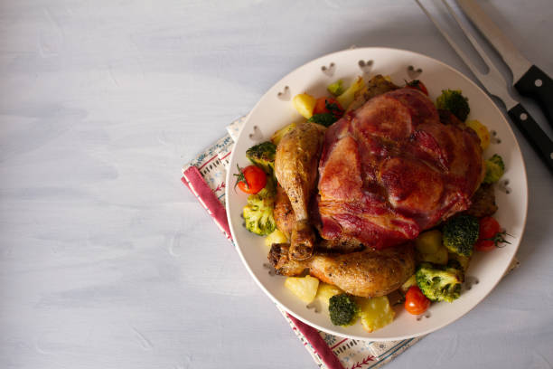 istock Whole roast chicken with breasts wrapped in bacon and vegetable 1220777947