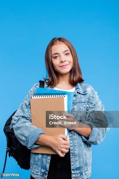 Portrait Of Female High School Student Holding Notebooks Stock Photo - Download Image Now