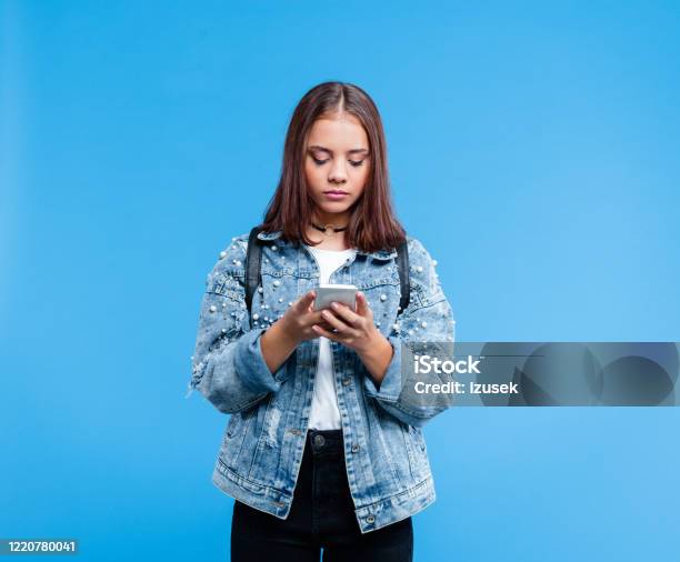 Portrait Of Female High School Student Using Smart Phone Stock Photo - Download Image Now