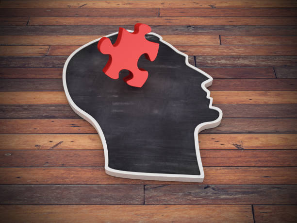 istock Human Head Shape with Jigsaw Piece on Wood Floor - 3D Rendering 1220780817