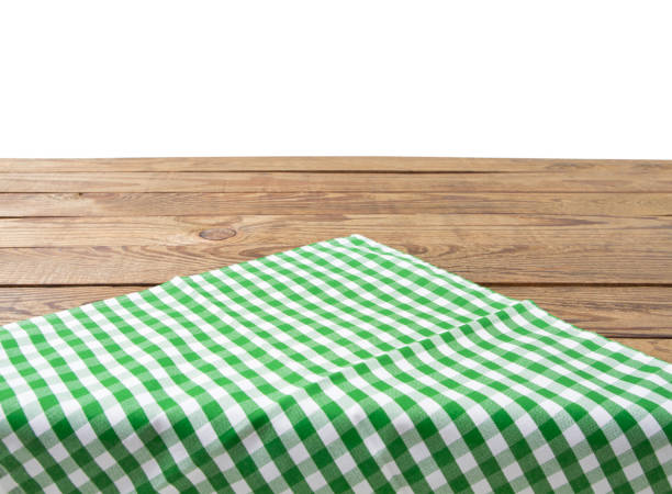 istock Brown old vintage wooden table with framed checkered tablecloth isolated on white. Thanksgiving day and Cristmas table concept. Top view and copy space. Selective focus 1220781985