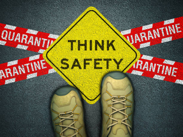 istock Feet on Asphalt Road with THINK SAFETY Road Sign - 3D Rendering 1220784768