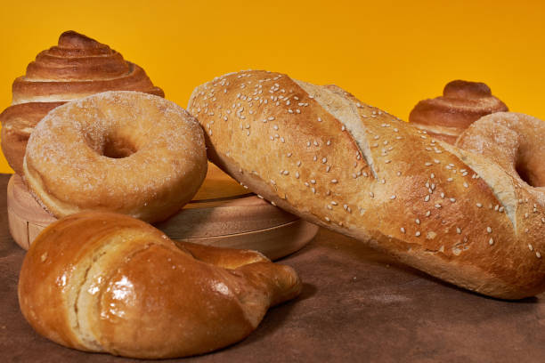 istock various types of breads and donuts with yellow background 1220787432