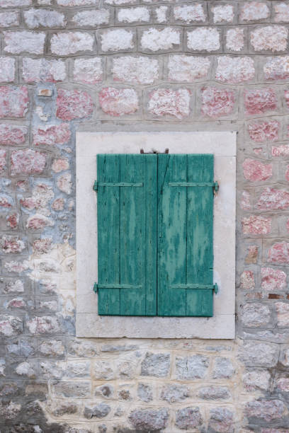 istock Old wooden window on the stone wall 1220788032