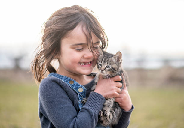 istock Girl and her kitten 1220788187