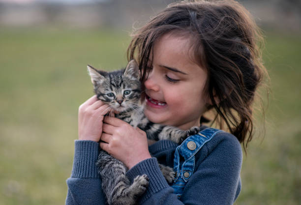 istock Girl and her kitten 1220788201