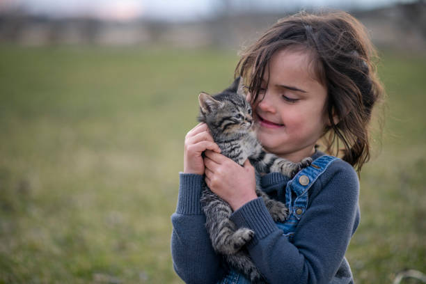 istock Girl and her kitten 1220788215