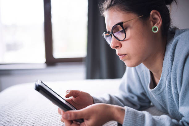 istock Woman Reading E-Book At Home 1220789747