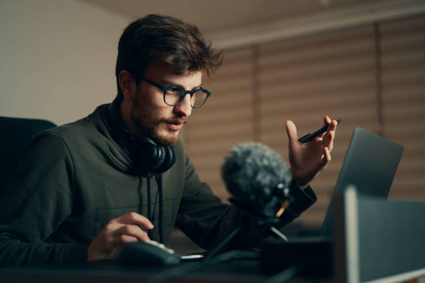 istock Young man in an online conference meeting explaining something. Online education equipments. 1220789999