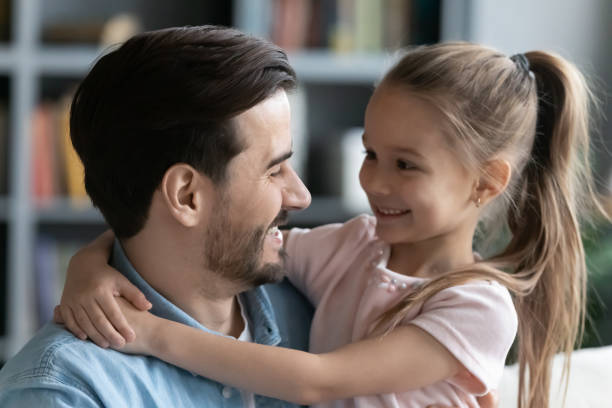 istock Dad and daughter hugging looking at each other with love 1220790952