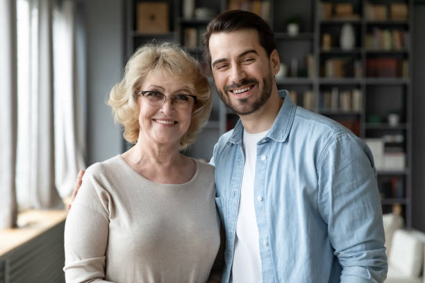 istock Elderly mother with grownup son posing indoors looking at camera 1220791057