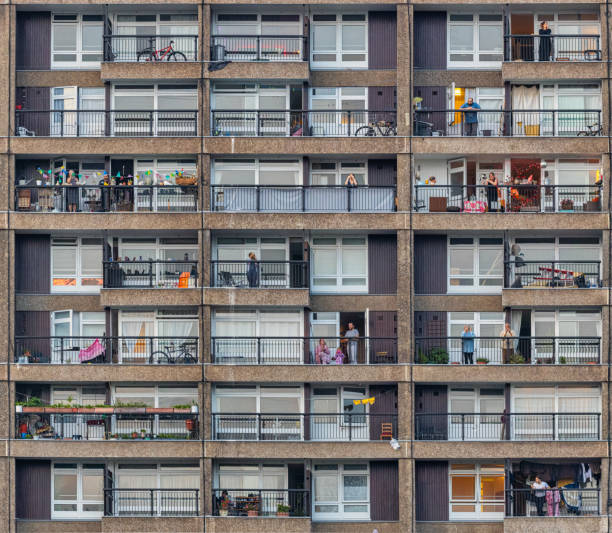 Social distancing during the Covid 19 pandemic during the NHS clap Thursday evening at 8pm The beautiful Brutalist Trellick Tower in London where the residents gather to clap their appreciation to the NHS and British key workers. trellick tower stock pictures, royalty-free photos & images
