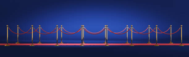 istock Golden barrier with red rope isolated on blue background. Clipping path included 1220792796